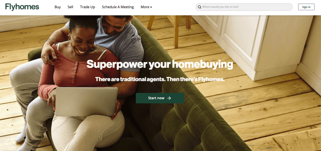 A husband and wife looking at homes on a laptop together